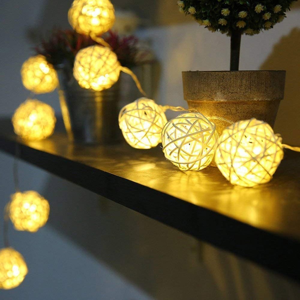 Rattan ring string lights with ten bulbs – shown lit in a room setting