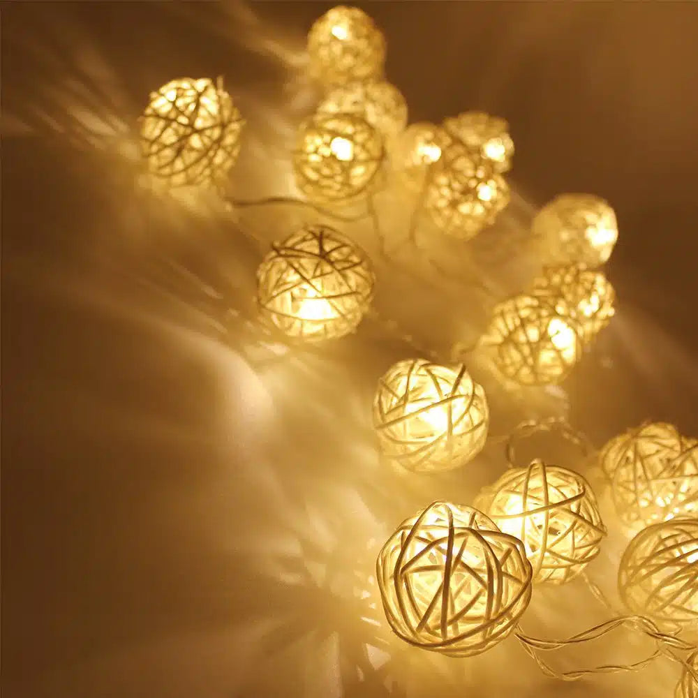 Rattan Christmas string lights with miniature woven shades – shown lit in a room setting (3)