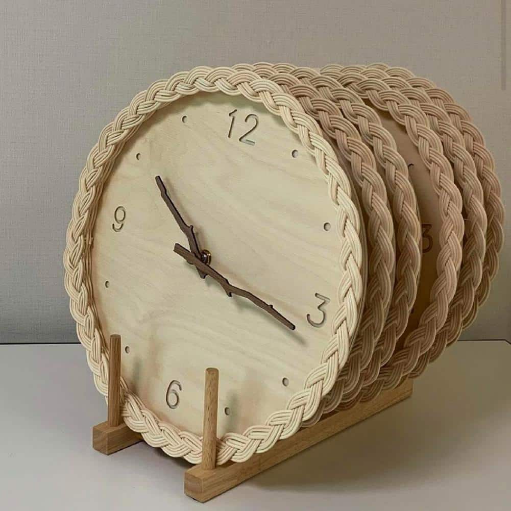 Round braided rattan wall clock with branch-shaped hands – close-up detail