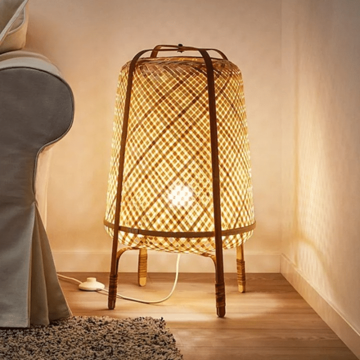 Japanese-style wicker LED floor lamp on legs – shown lit in a room setting