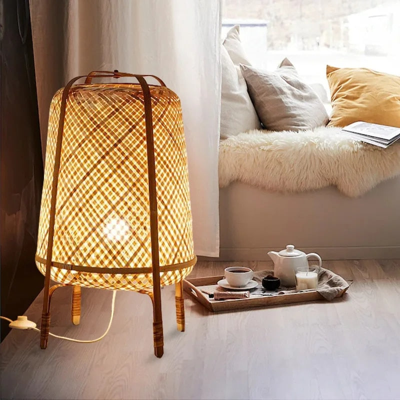 Japanese-style wicker LED floor lamp on legs – shown lit in a room setting (2)