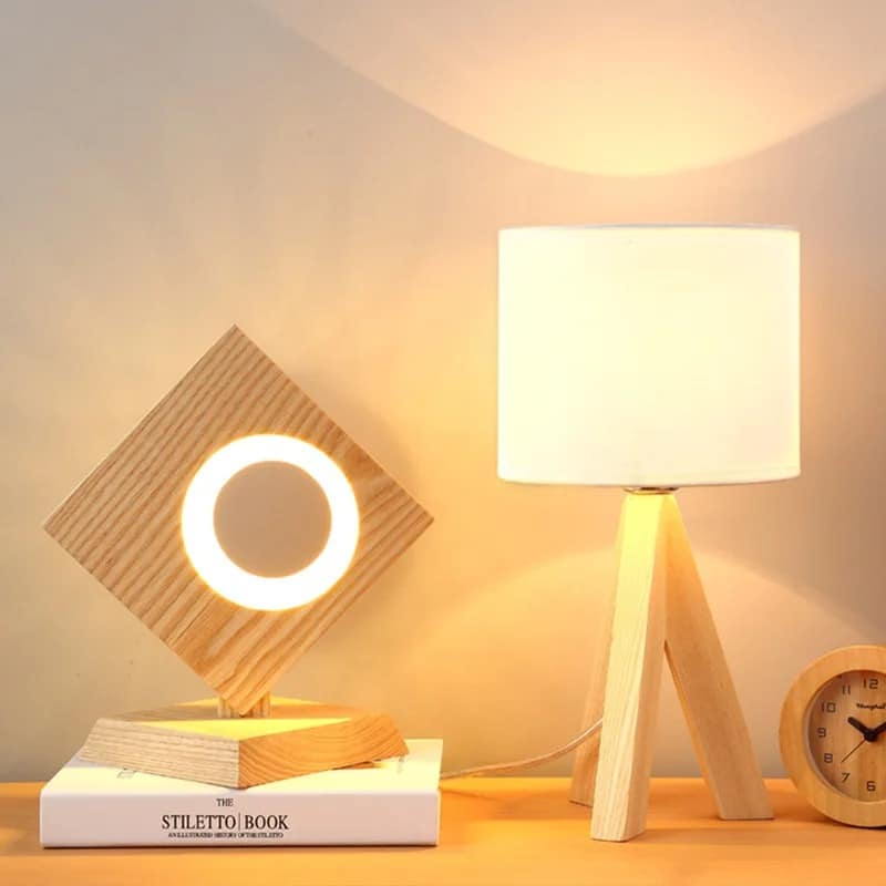 Contemporary natural wood bedside lamp with a handwoven shade – shown lit in a room setting