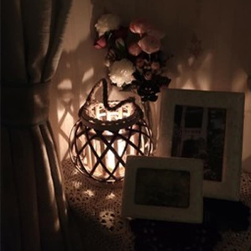Square retro rattan lantern with spiral woven rope – shown lit in a room setting