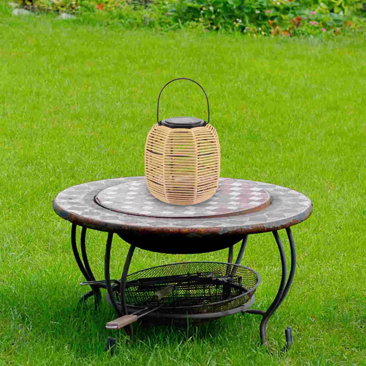 Rustic solar rattan lantern with an iron frame – shown outdoors