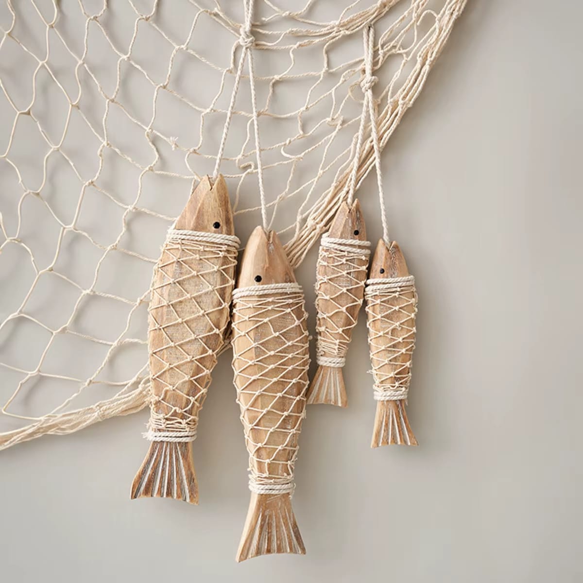 Set of two carved wooden fish wall decorations – shown in a room setting (3)