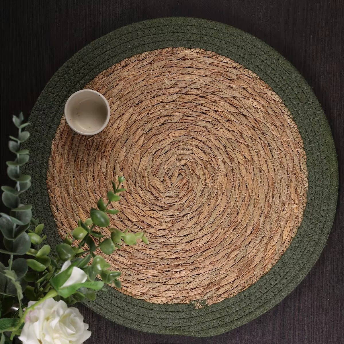 Set of four vintage-style straw placemats with golden highlights – shown in a room setting