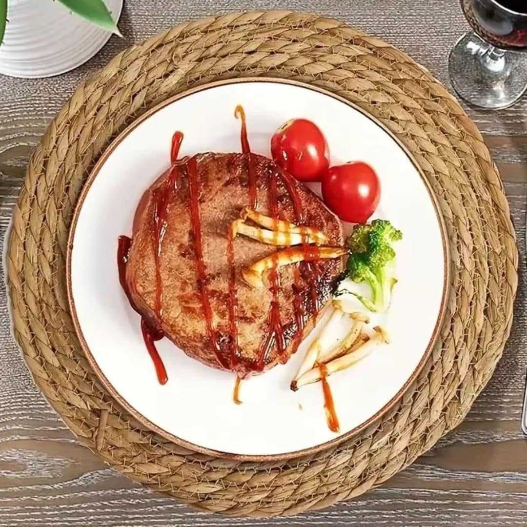 Set of six round braided straw placemats – shown in a room setting