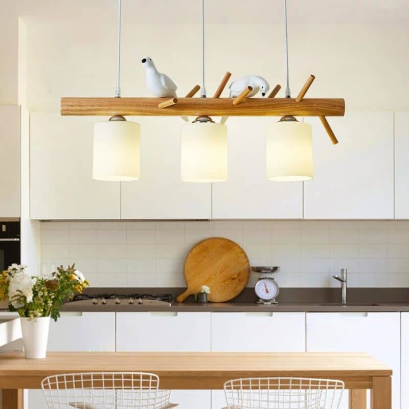 Modern geometric solid wood chandelier with a natural finish – shown in a room setting (2)