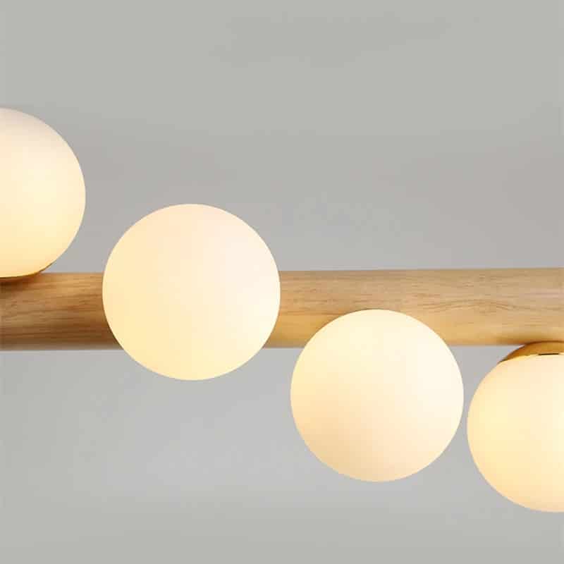 Nordic chandelier with seven frosted glass globes on a natural wood frame – close-up detail