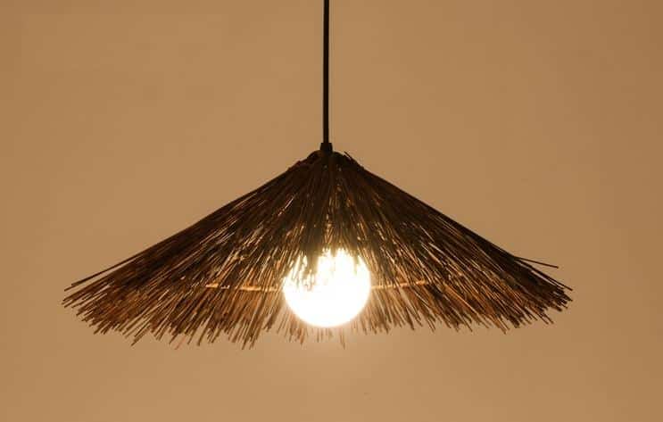 Round brown bamboo and wood chandelier with a tight weave – shown lit