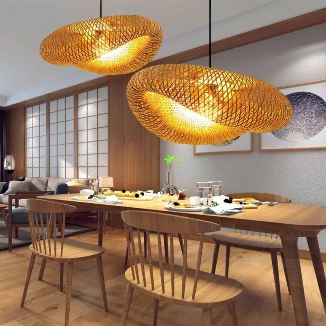 Wavy natural rattan chandelier with a golden tight weave – shown in a room setting (3)