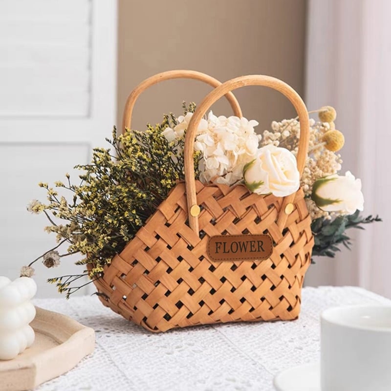 Mini woven flower basket with painted florals and white fabric lining – shown in a room setting
