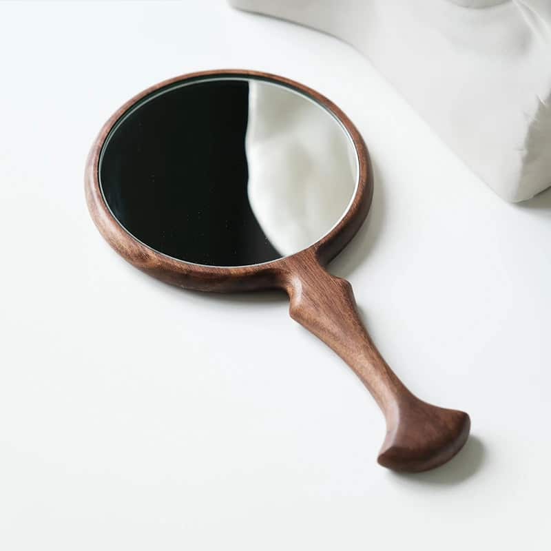Round retro wooden hand mirror with a braided handle – close-up detail