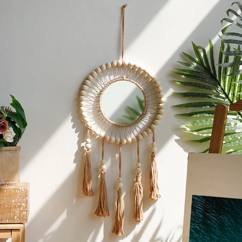 Wooden mirror with macramé fringe and hanging beads – shown in a room setting