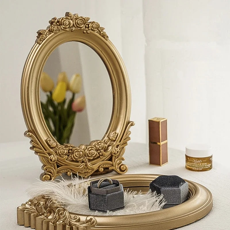 Oval wood-look mirror framed by gold molding – shown in a room setting