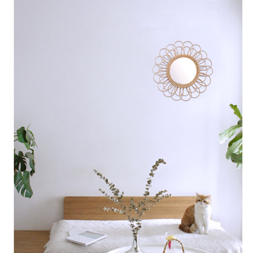 Large flower-shaped mirror with radiating natural rattan petals – shown in a room setting