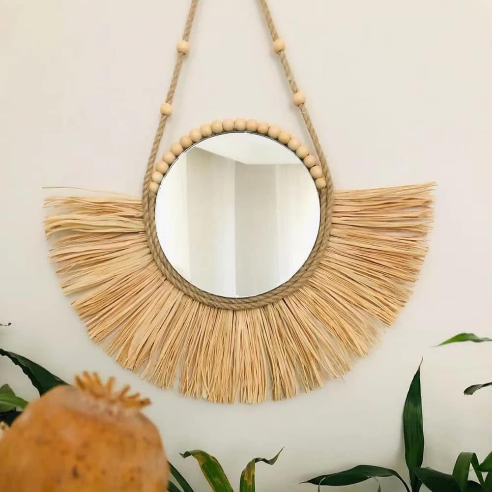 Round braided straw mirror edged with a trim of beads – shown in a room setting