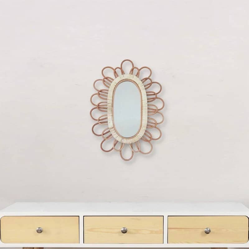Oval rattan wall mirror with a hand-braided frame – shown in a room setting (3)