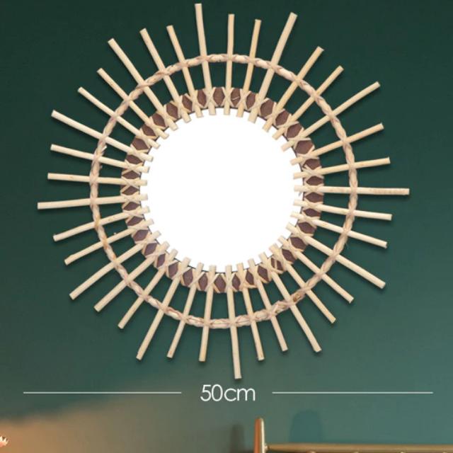 Large beige rattan sun mirror with a crown of braided rays – shown in a room setting (3)