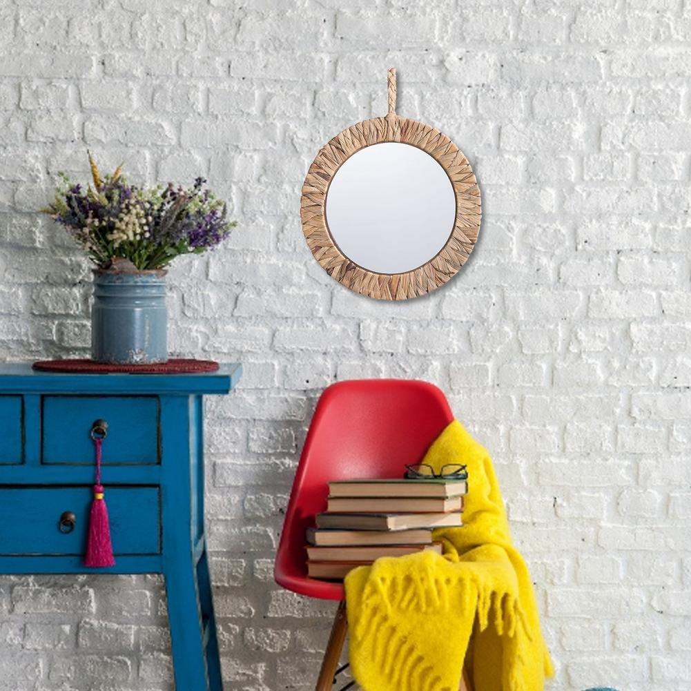 Natural rattan sun mirror with rays radiating from a circular frame – shown in a room setting (3)