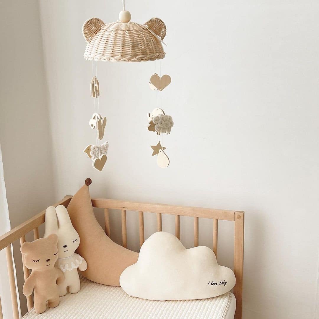 Rattan baby mobile with four hand-braided balls – shown in a room setting