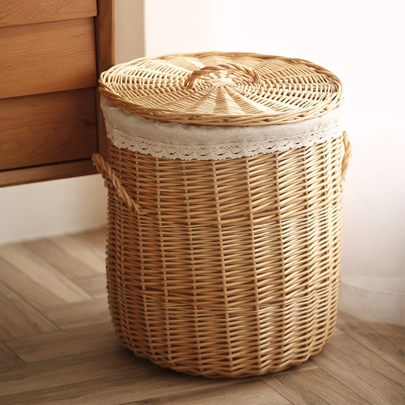 Hand-braided rattan laundry basket with a removable lid and handles – shown in a room setting (3)