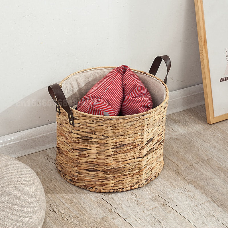 Rattan laundry basket with two handles woven into its structure – shown in a room setting (3)