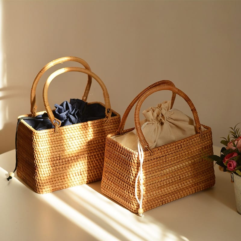 Vintage round rattan basket bag with generous handles – shown in a room setting (2)