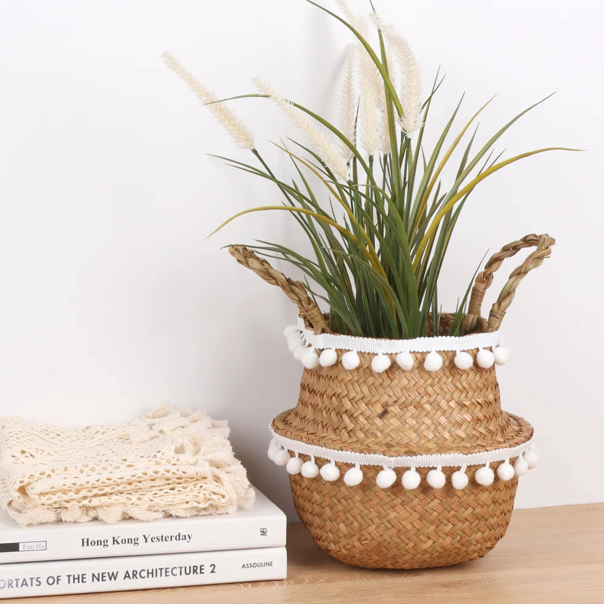 Round rattan basket with hand-knotted tassels – shown in a room setting (2)