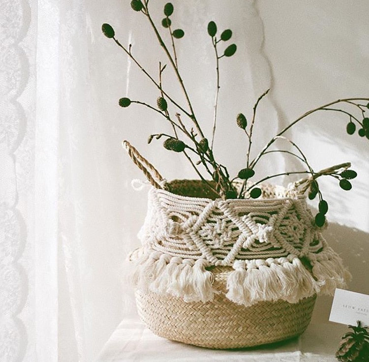Decorative round rattan basket with a macramé pompom and fringe – shown in a room setting (2)