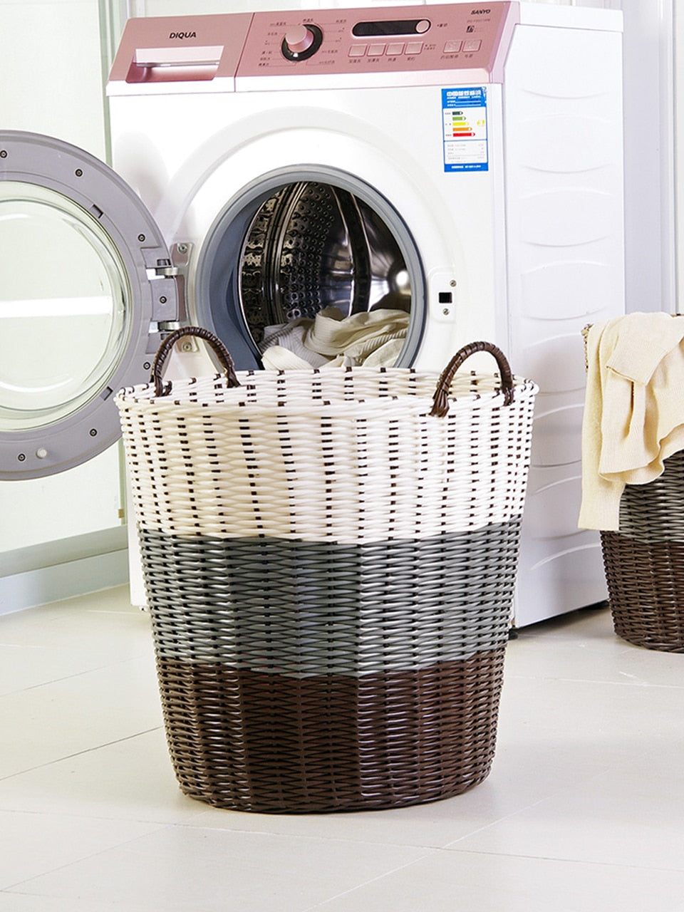 Foldable woven rattan laundry basket – shown in a room setting (2)