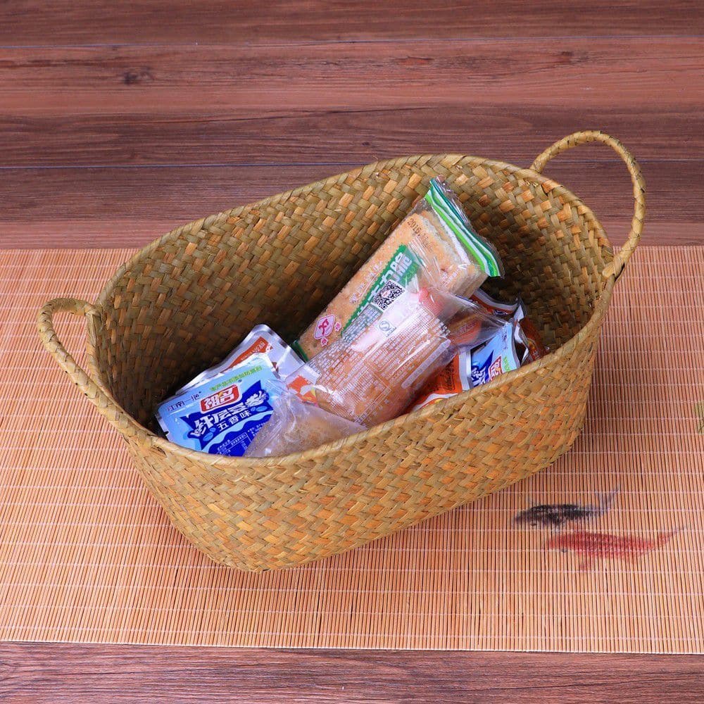 Natural wicker storage basket with side handles – shown in a room setting