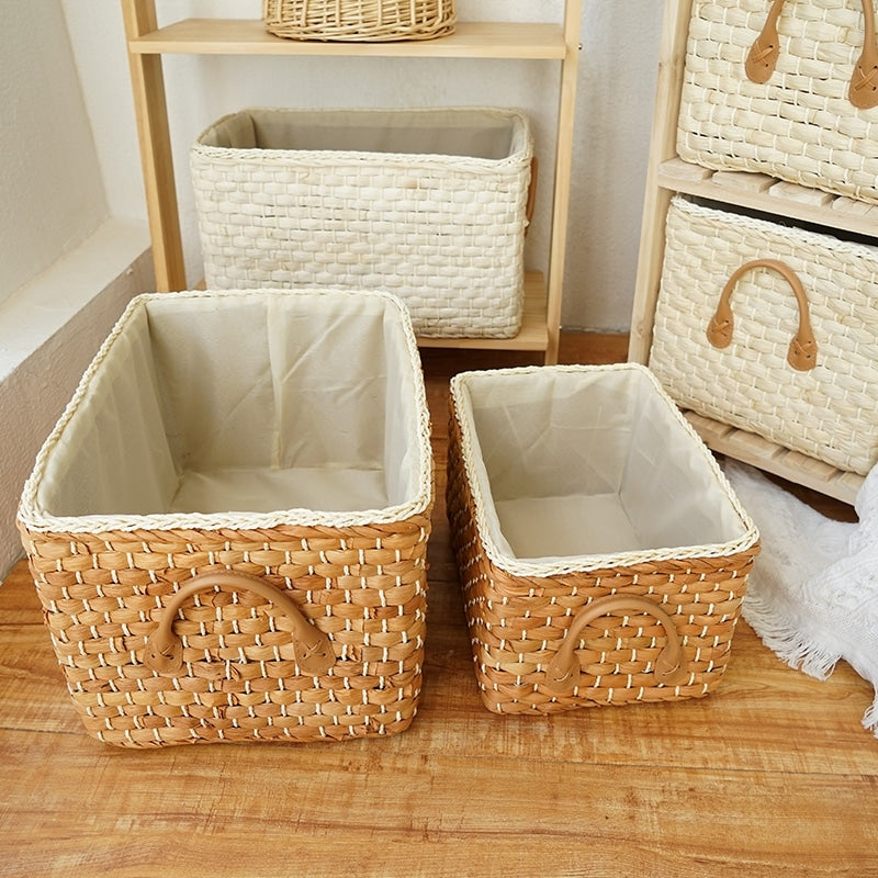 Handwoven wicker storage basket with two handles – shown in a room setting (4)