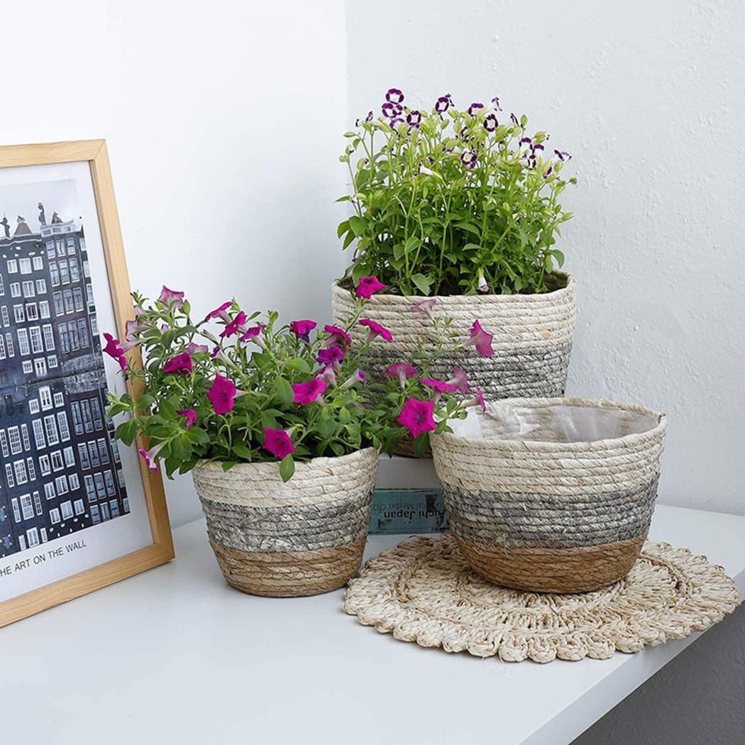 Woven rattan storage basket with integrated handles – shown in a room setting (2)