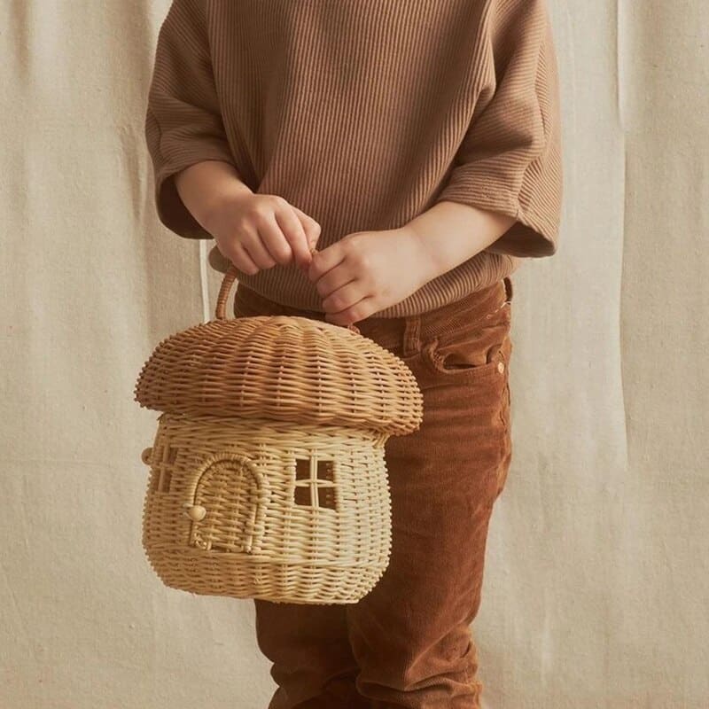 Handwoven rattan storage basket shaped like a little house – shown in use