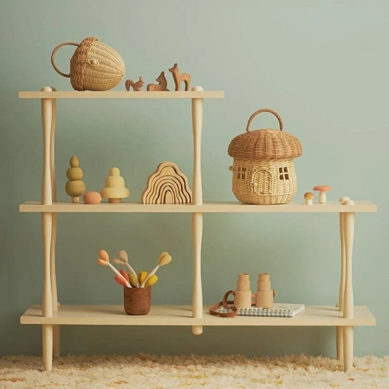 Handwoven rattan storage basket shaped like a little house – shown in a room setting