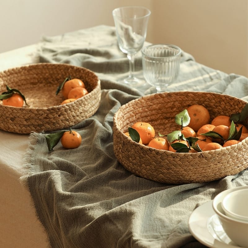 Round handwoven rattan basket with a center handle – shown in a room setting (2)