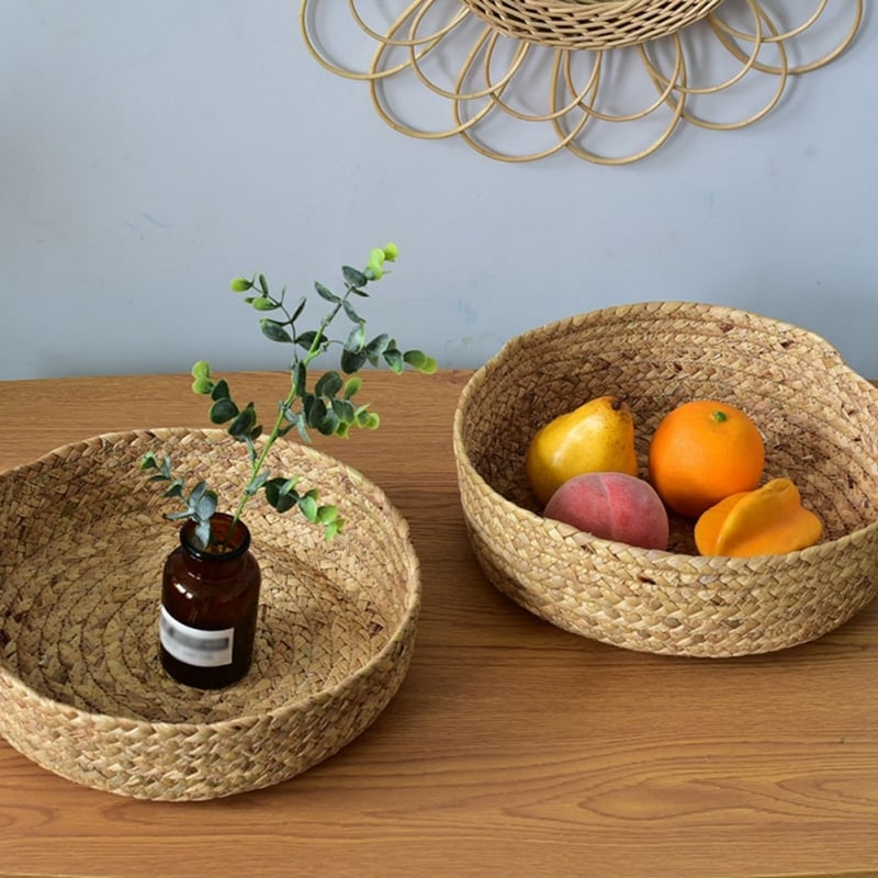 Round handwoven rattan basket with a center handle – shown in a room setting (3)