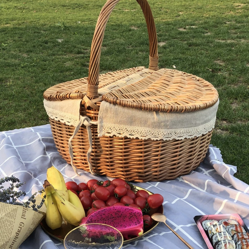 Retro wicker picnic basket with round handles – shown outdoors