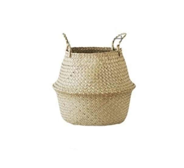 Round handwoven rattan planter basket hiding a plant pot