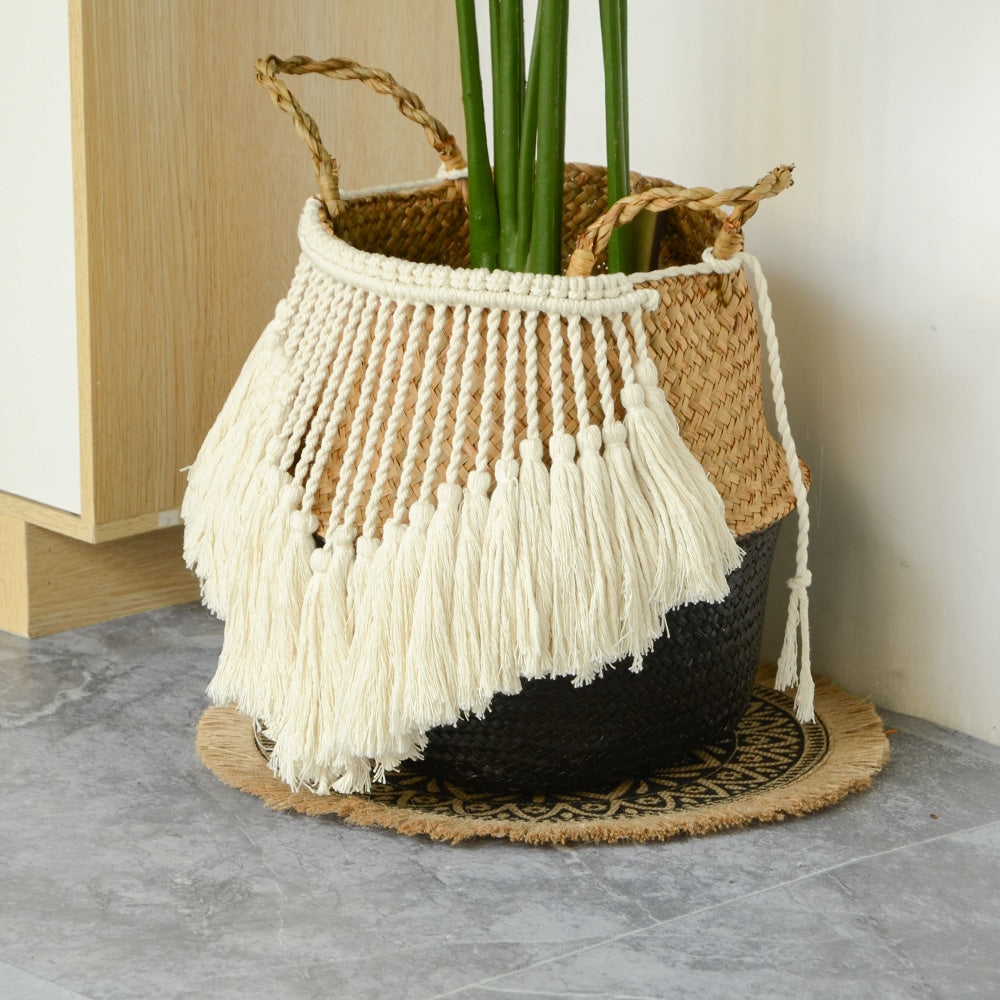 Black and beige wicker basket with a fringed border and white pompoms – shown in a room setting (3)