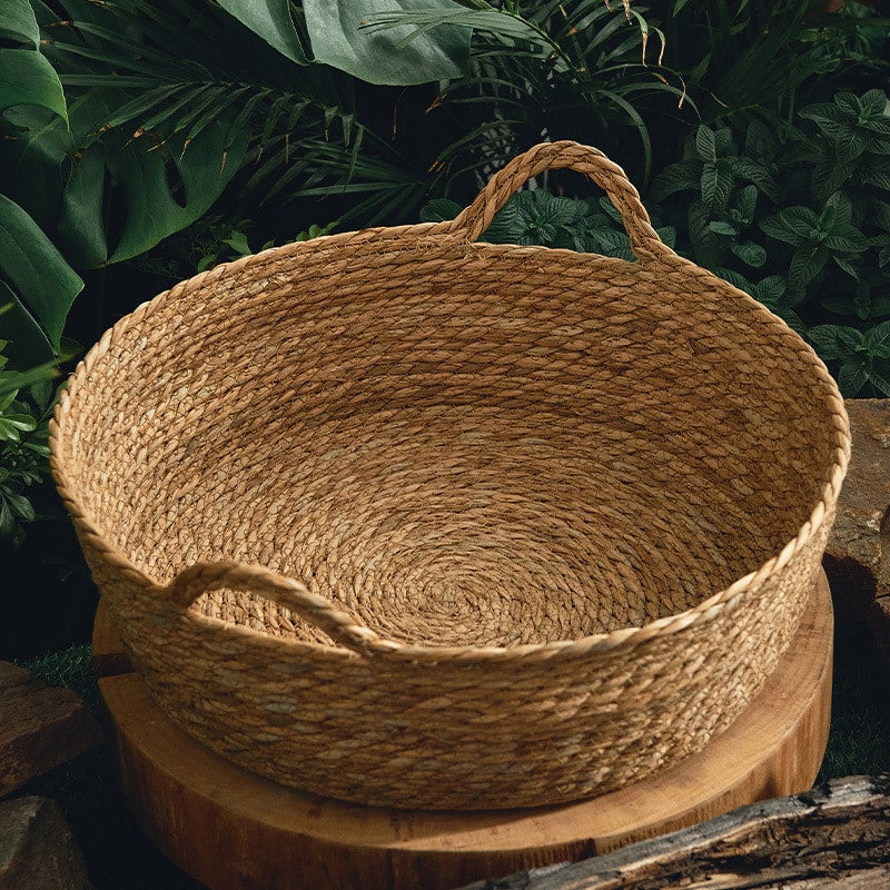 Handwoven rattan dog bed – shown in a room setting