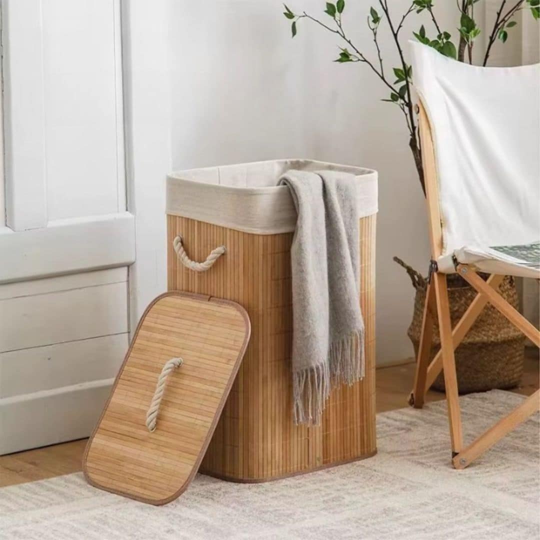 Rattan and bamboo laundry basket with sturdy handles – shown in a room setting (2)