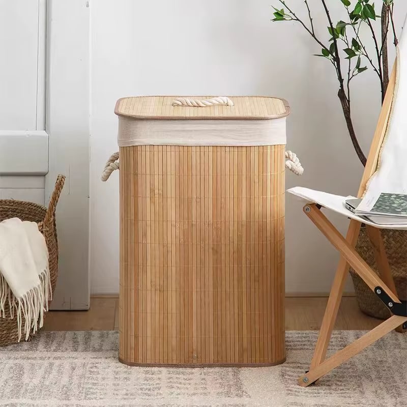 Rattan and bamboo laundry basket with sturdy handles – shown in a room setting (3)
