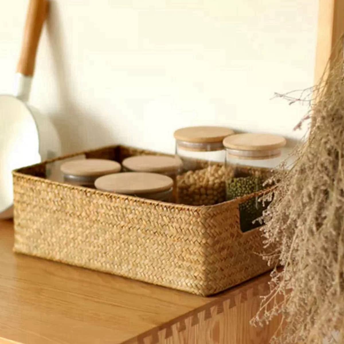 Natural fiber woven storage basket with sturdy handles – shown in a room setting (3)