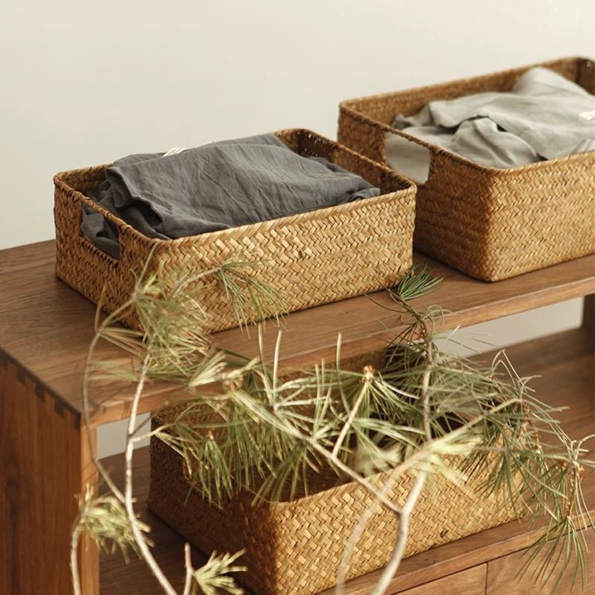 Natural fiber woven storage basket with sturdy handles – shown in a room setting