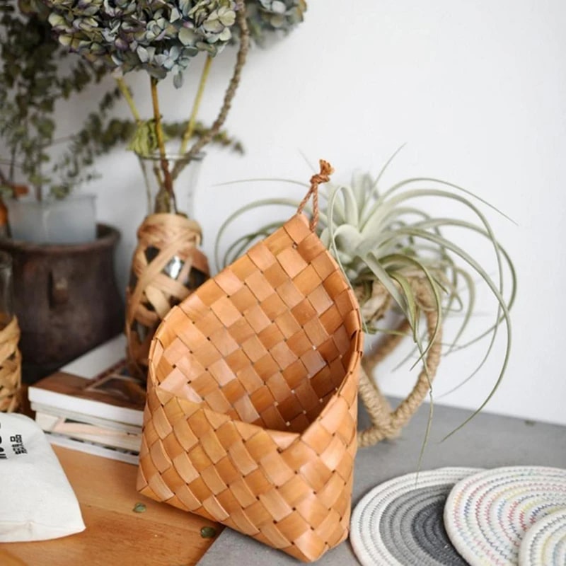 Vintage rattan-look round handwoven storage basket – shown in a room setting