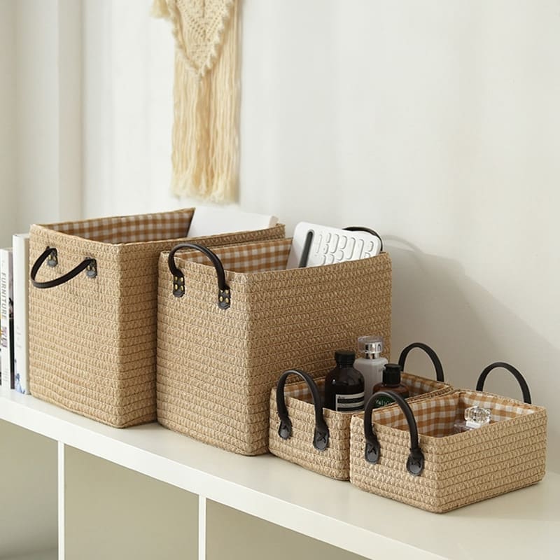 Square hand-braided rattan box basket with two handles – shown in a room setting