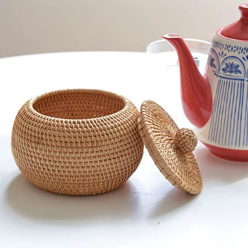 Retro round rattan storage basket with bulging sides and a braided lid – shown in a room setting