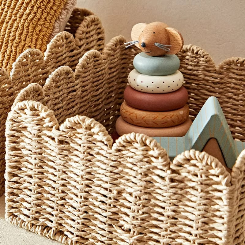 Generous woven rattan storage basket with sturdy handles – shown in a room setting